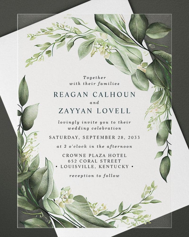Wedding invitation with green watercolor floral border, announcing the marriage of Reagan Calhoun and Zayyan Lovell.