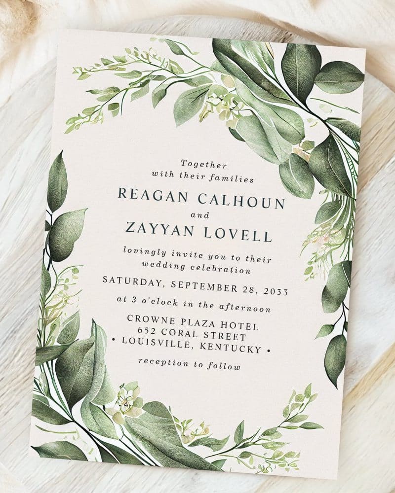 Wedding invitation for Reagan Calhoun and Zayyan Lovell, featuring a leafy green botanical design.