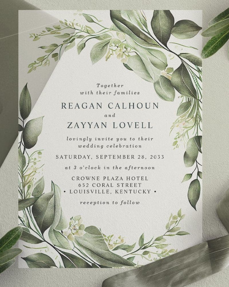 Wedding invitation with green foliage border; Reagan Calhoun and Zayyan Lovell's names are prominently displayed.