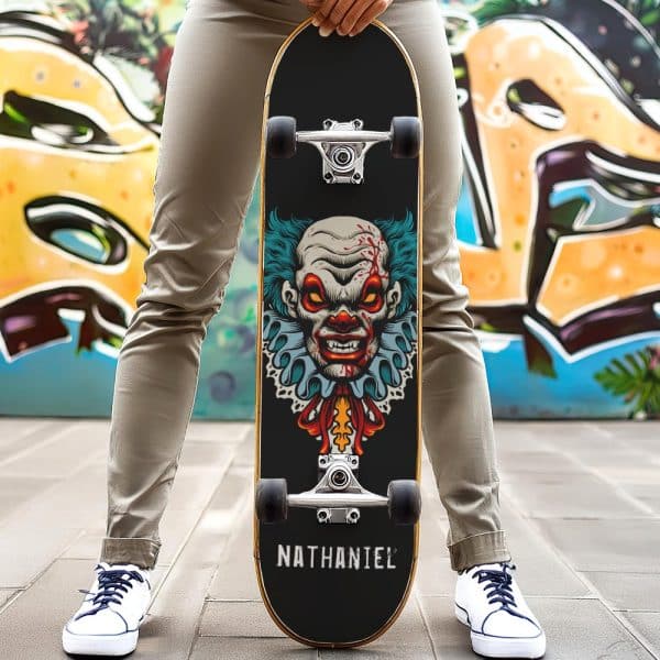 Person Holding A Skateboard With A Scary Clown Graphic.