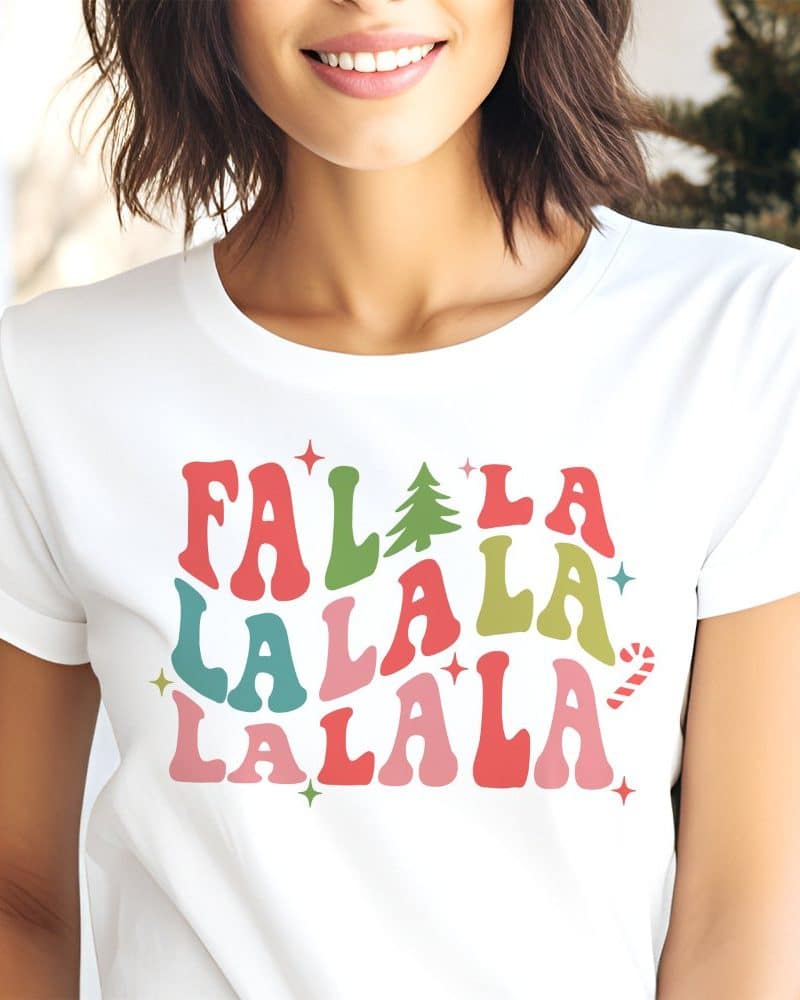 Woman wearing a white t-shirt with a colorful Falala design.