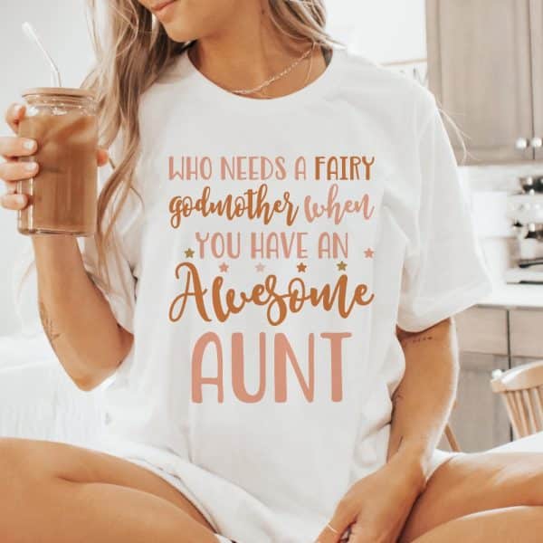 Woman Wearing A White T-Shirt That Says, Who Needs A Fairy Godmother When You Have An Awesome Aunt.
