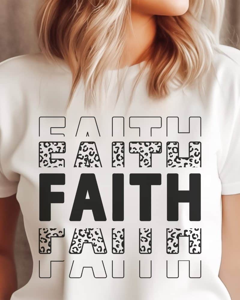 White t-shirt with the word FAITH repeated in a layered design. Some letters have a leopard print pattern.