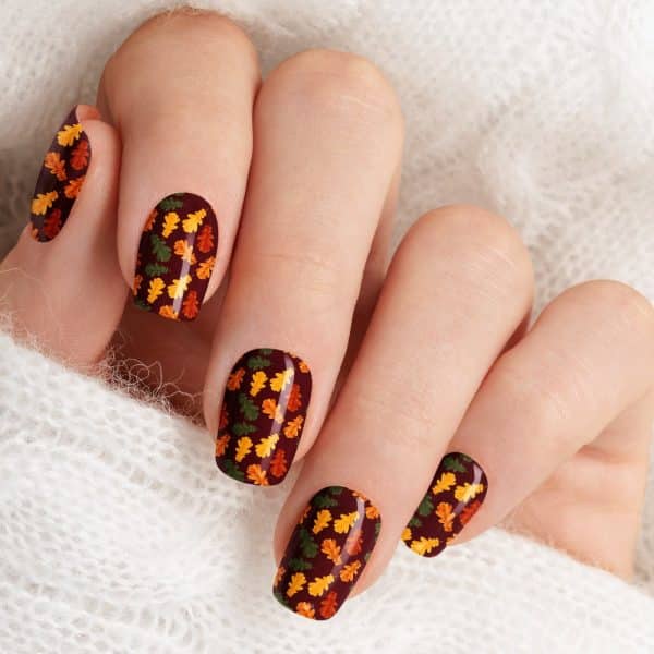 Close-Up Of Fingernails With Autumn Leaf Nail Art.