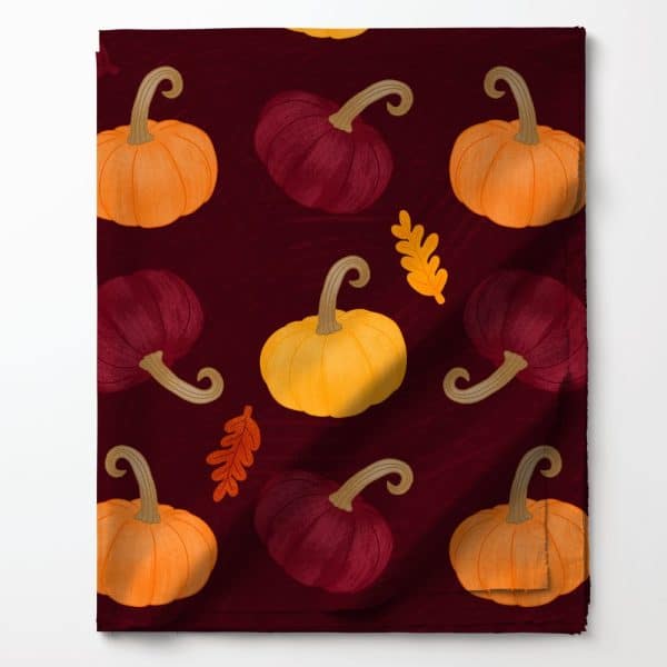 Burgundy Fabric With A Repeating Pattern Of Orange, Yellow, And Maroon Pumpkins And Autumn Leaves.