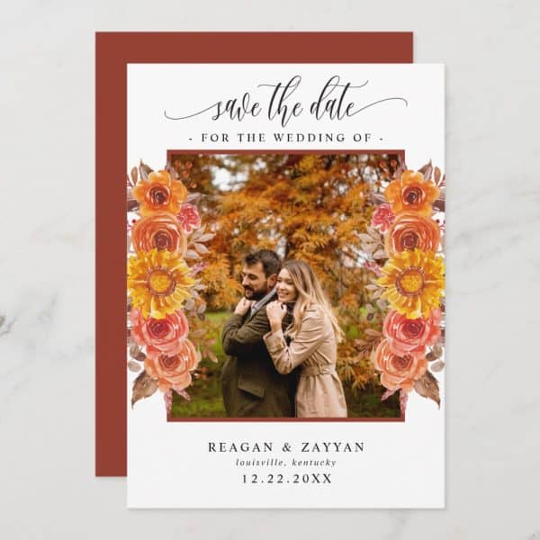 Save The Date Card With A Photo Of A Couple Embracing, Framed By Autumnal Flowers.