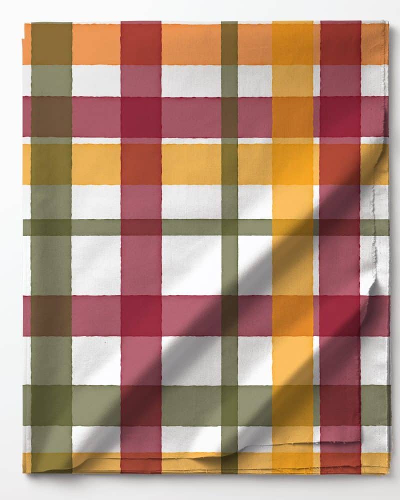 Partially folded fabric with a plaid pattern in muted autumnal colors.