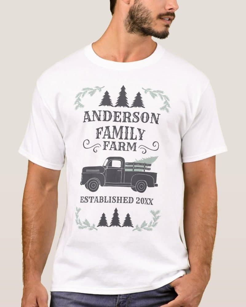 White t-shirt with Anderson Family Farm design; features a vintage truck carrying a Christmas tree.