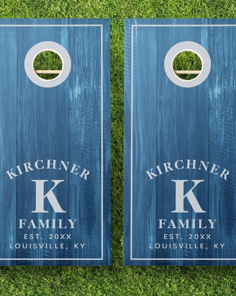 Pair of blue personalized cornhole boards, each displaying the Kirchner family name, initial K, and establishment year.