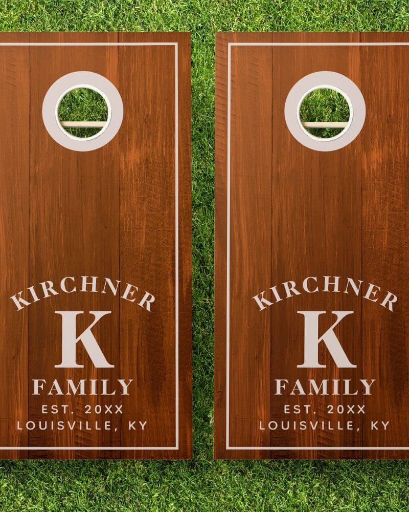 Pair of brown wooden cornhole boards, each personalized with the Kirchner family name, initial K, establishment year, and location.