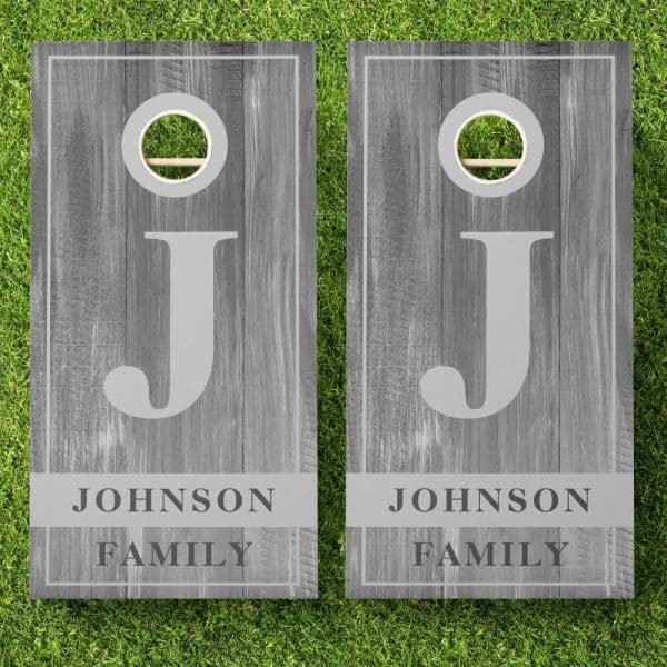 Two Gray Wooden Cornhole Boards, Each Displaying A Large Letter J And The Text Johnson Family.