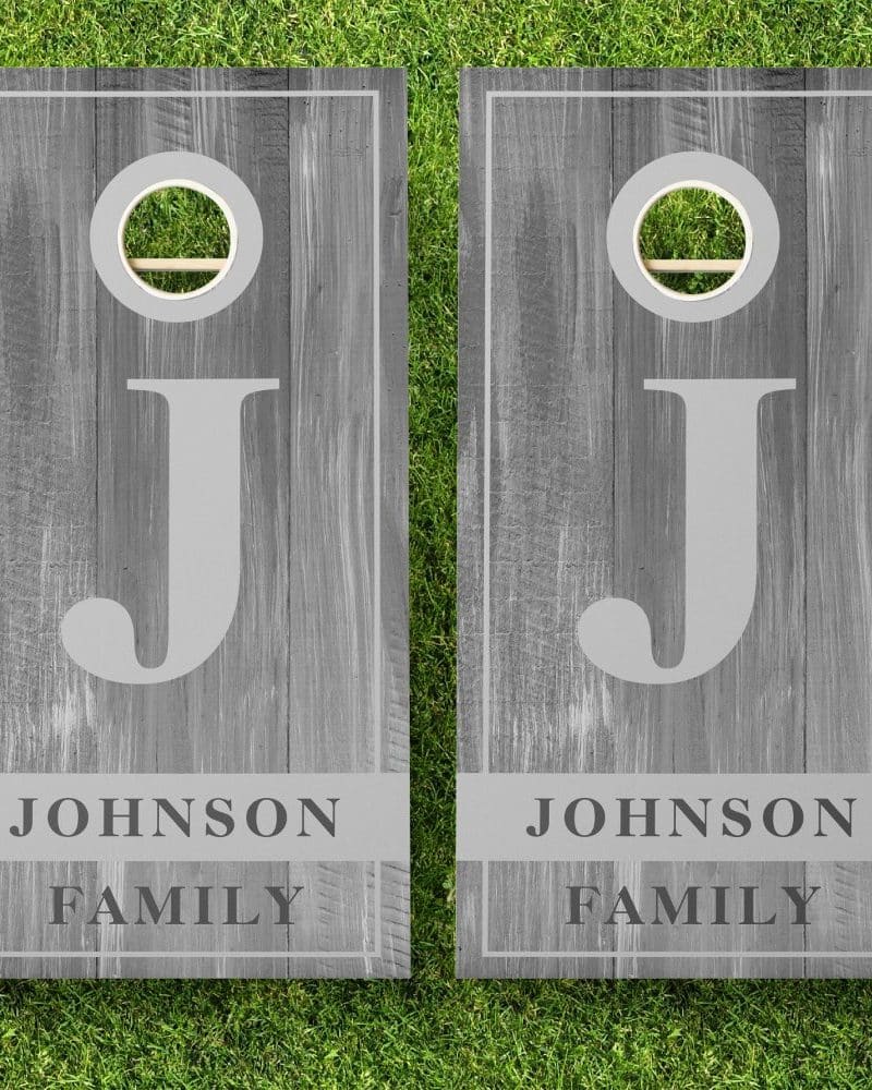 Two gray wooden cornhole boards, each displaying a large letter J and the text Johnson Family.