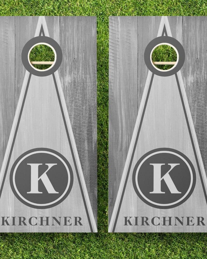 Pair of gray personalized cornhole boards with the initial K and the last name Kirchner.