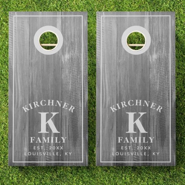 Two Gray Wooden Cornhole Boards, Personalized With The Kirchner Family Name And Initial K.