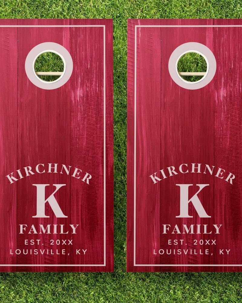 Pair of red personalized cornhole boards with the Kirchner family name and initial K.