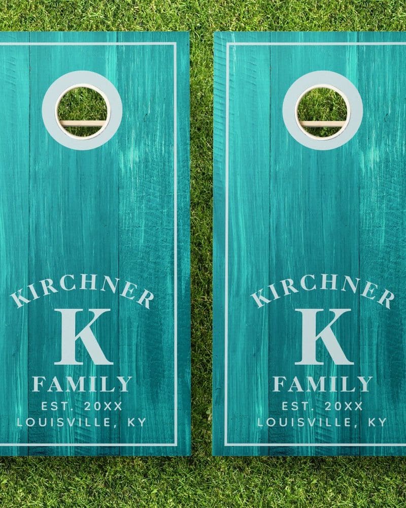 Pair of teal cornhole boards with the Kirchner family name, initial K, and establishment year.