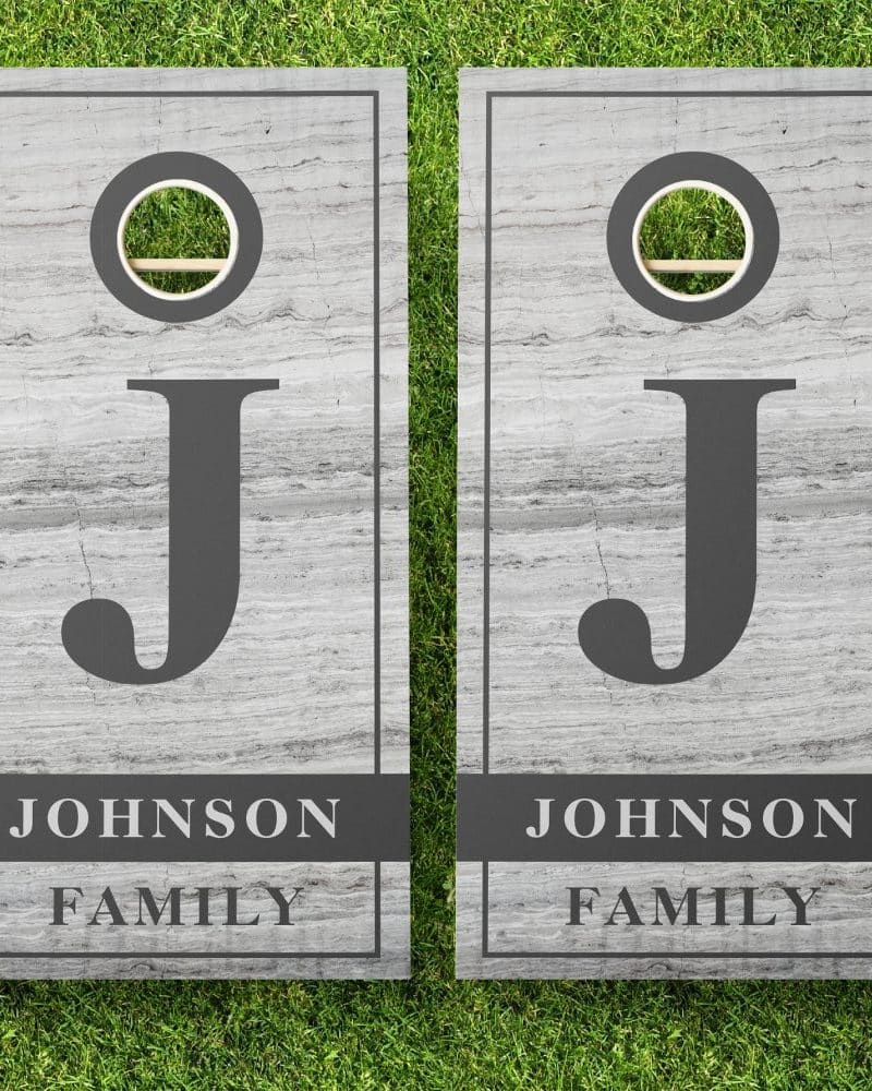 Pair of gray wooden cornhole boards, each displaying a large letter J and the text Johnson Family.
