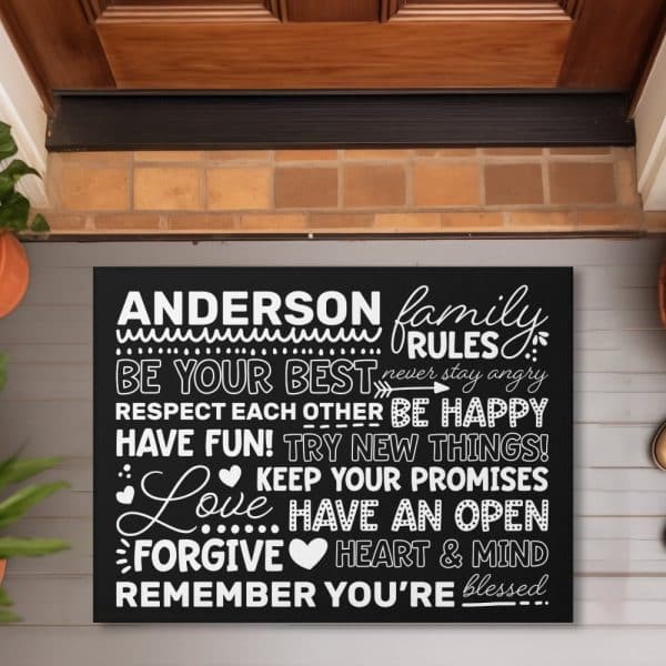 Black Welcome Mat With The Anderson Family Rules In White Lettering.