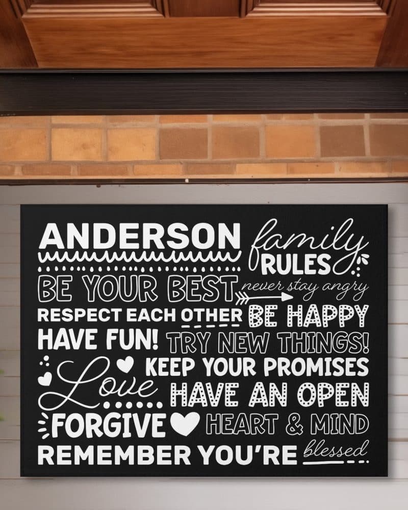 Black welcome mat with the Anderson family rules in white lettering.