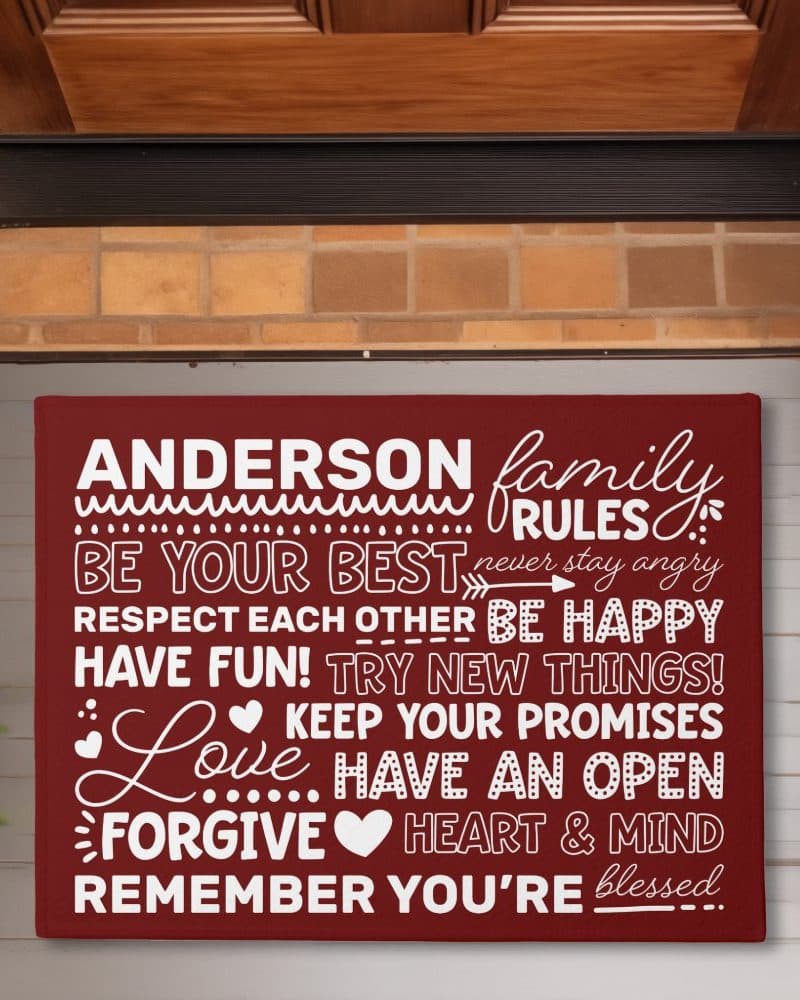 A maroon doormat with the Anderson family rules, including being your best, respecting each other, and keeping your promises.