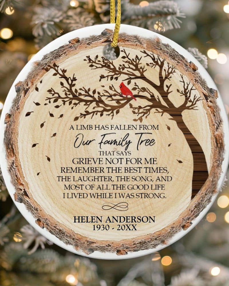 Round wooden-style Christmas ornament featuring a tree with a cardinal, commemorating Helen Anderson.