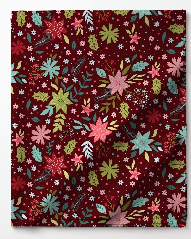 Red fabric with a repeating pattern of stylized poinsettias and other flowers in shades of pink, green, and teal.