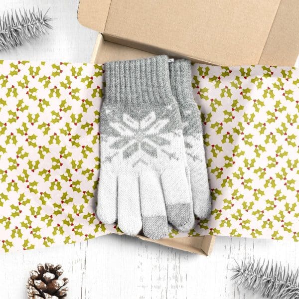 Grey And White Knit Gloves With A Snowflake Pattern, Presented In A Gift Box Lined With Holly-Patterned Paper.
