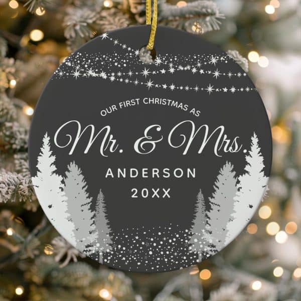 Dark Gray Round Christmas Ornament With Silver Trees, Snowflakes, And Stars; Text Reads &Quot;Our First Christmas As Mr. &Amp; Mrs. Anderson 20Xx&Quot;.