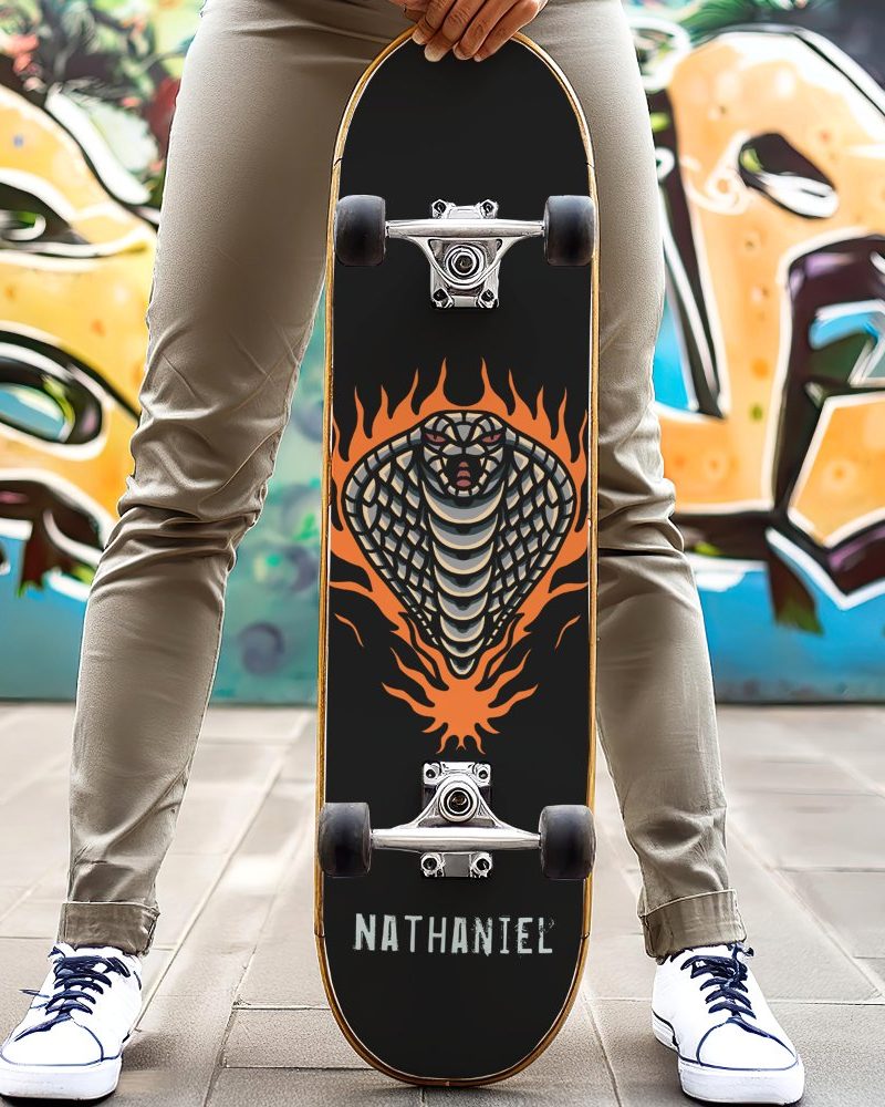 Person holding a skateboard with a cobra in flames graphic.