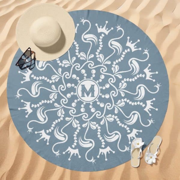 Blue Round Beach Towel With A White Mandala Design, Featuring Crowns And The Letter M In The Center.