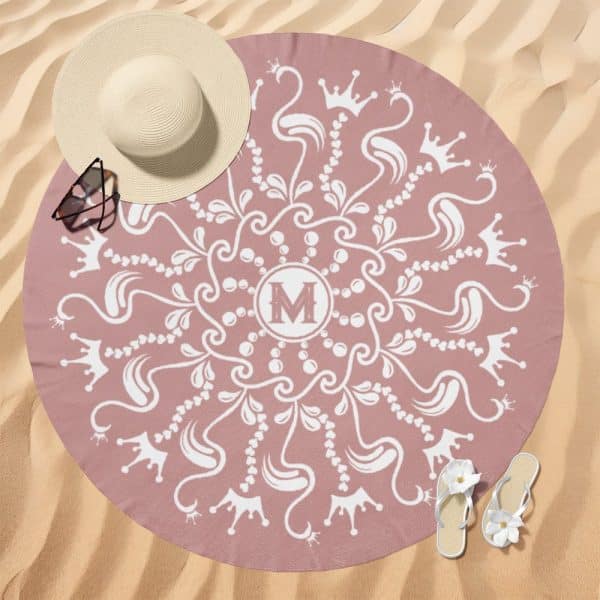 Pink Round Beach Towel With A White Mandala Design Featuring Crowns And The Initial M.