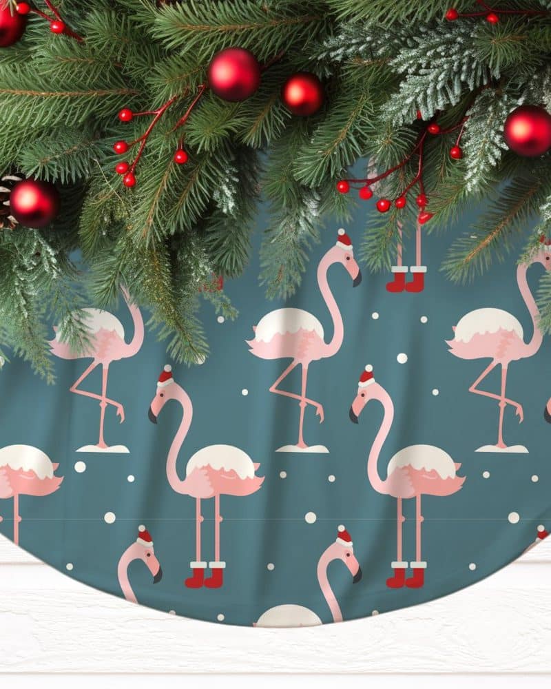 Christmas tree skirt featuring a teal background and a repeating pattern of pink flamingos wearing Santa hats and boots.