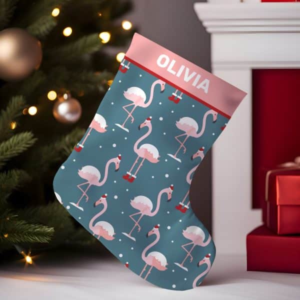 Personalized Christmas Stocking With A Teal Background And A Repeating Pattern Of Pink Flamingos Wearing Santa Hats. The Stocking Is Labeled Olivia.
