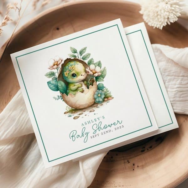 Baby Shower Invitation Featuring A Cute Green Dinosaur Hatching From An Egg Surrounded By Flowers.
