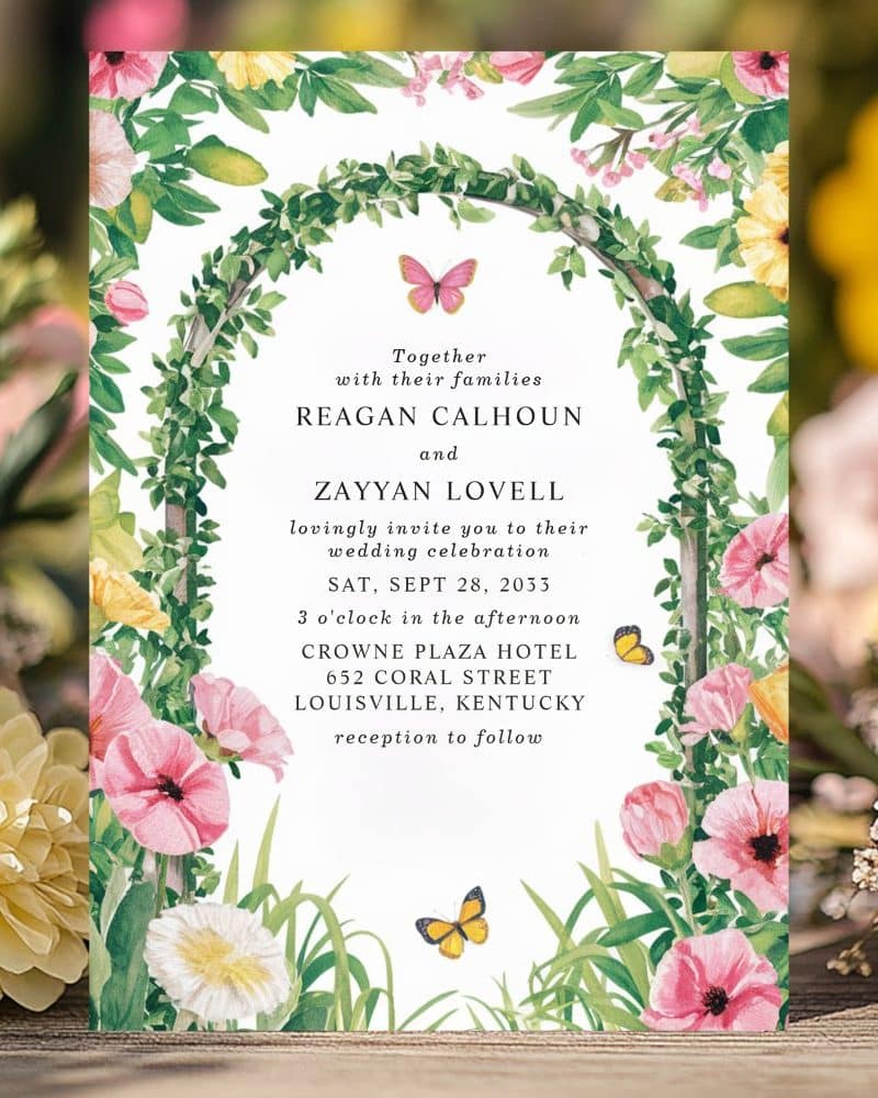 Wedding invitation with floral border and butterflies. The invitation announces the marriage of Reagan Calhoun and Zayyan Lovell.