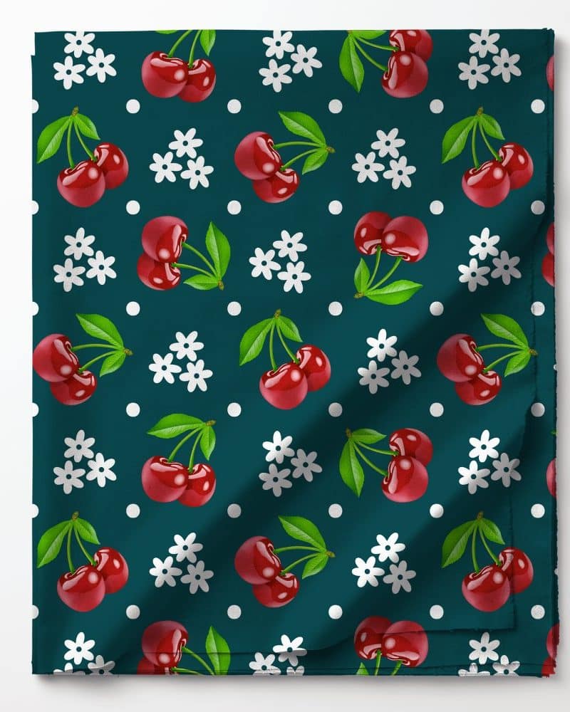Teal fabric with a repeating pattern of red cherries and white flowers.