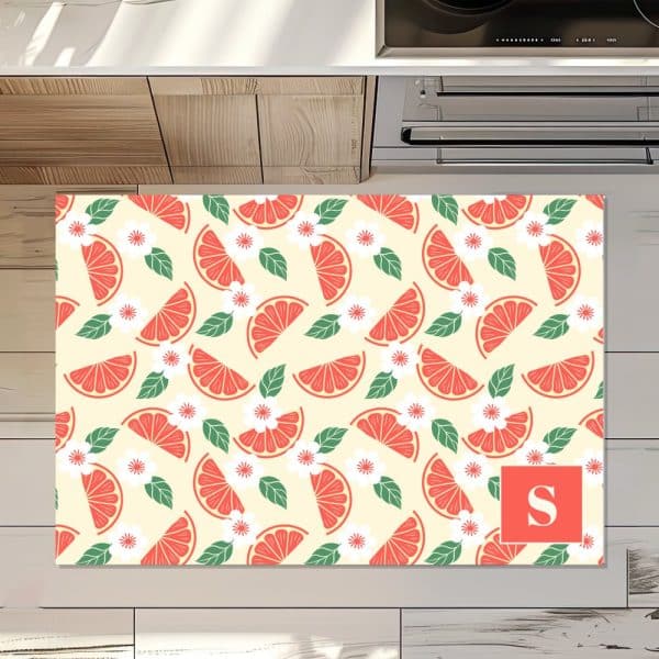 Personalized Kitchen Mat With A Repeating Pattern Of Grapefruit Slices And Flowers. The Letter S Is In The Lower Right Corner.
