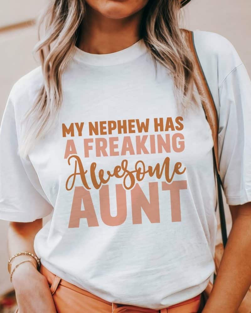 Woman wearing a white t-shirt that says My Nephew Has a Freaking Awesome Aunt.