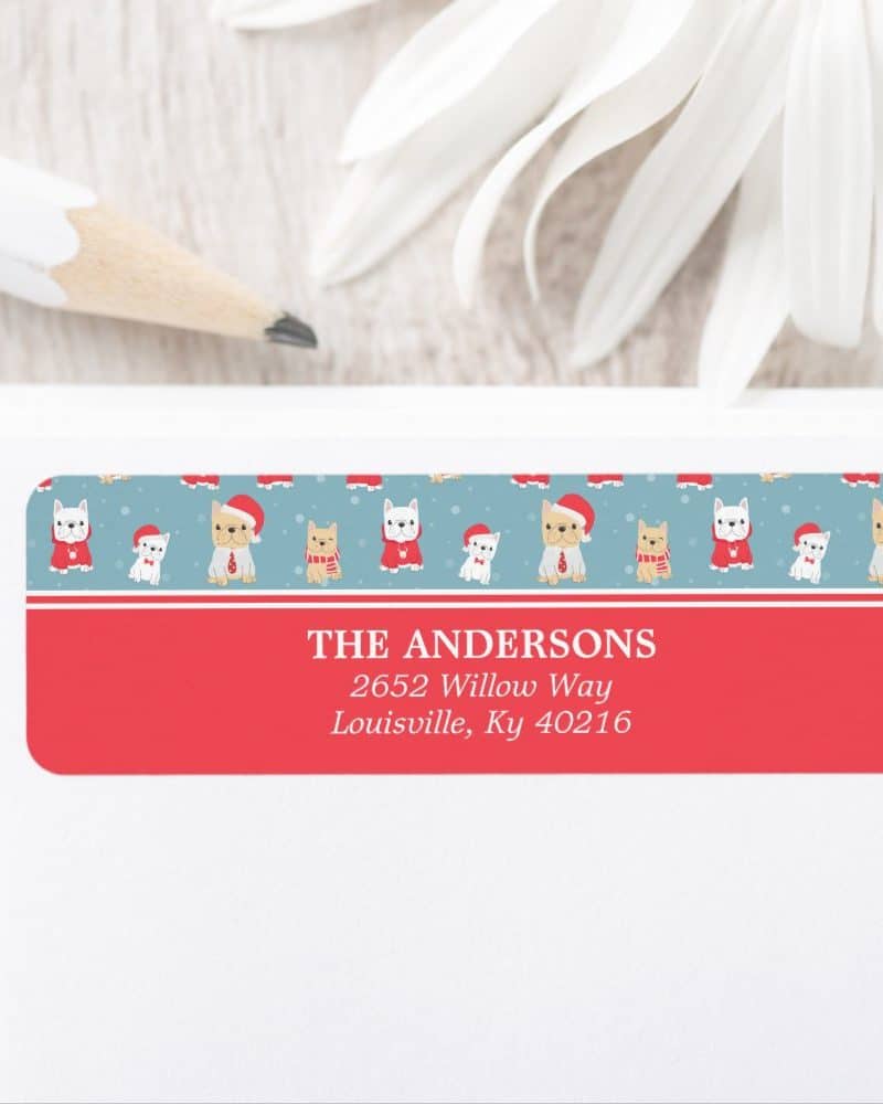 Christmas return address label with a pattern of dogs wearing Santa hats. The Andersons' address is printed below.