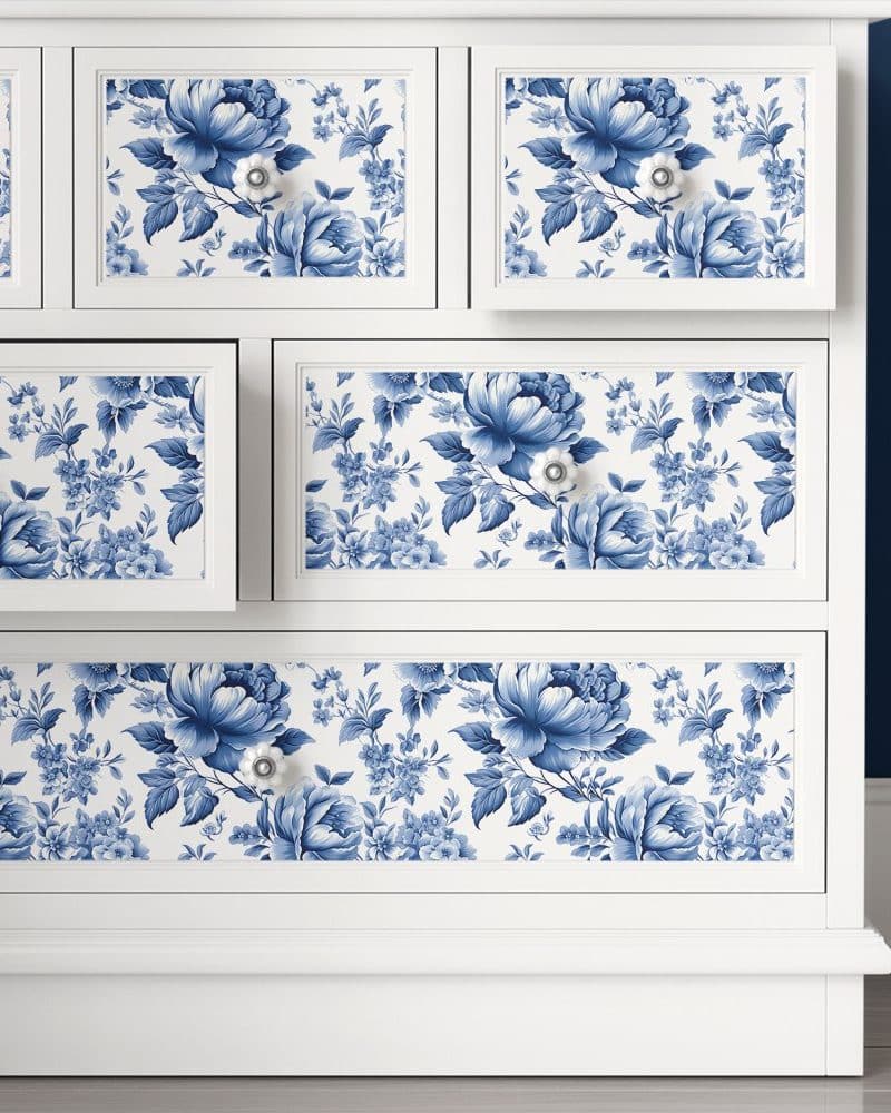 White dresser with blue and white floral drawer liners.