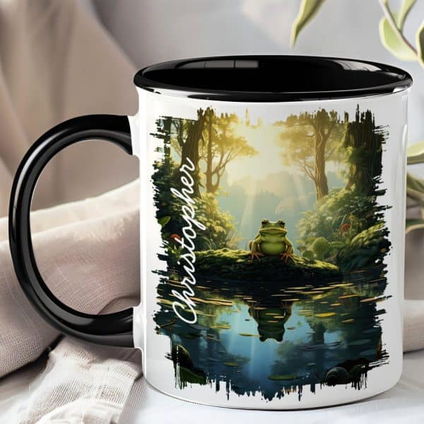 Black-Handled Mug With A Whimsical Illustration Of A Frog Sitting On A Log By A Pond In A Sun-Dappled Forest. The Name Christopher Is Printed On The Mug.