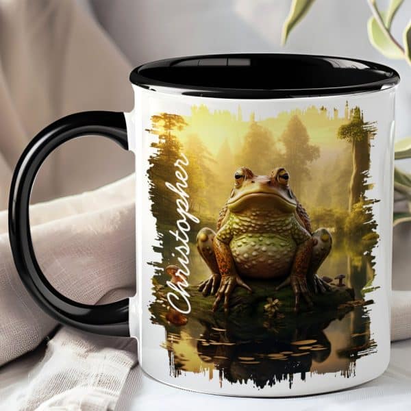 White Coffee Mug With A Black Handle And Rim, Featuring A Large Toad Sitting By Water In A Forest Scene. The Name Christopher Is Printed On The Mug.
