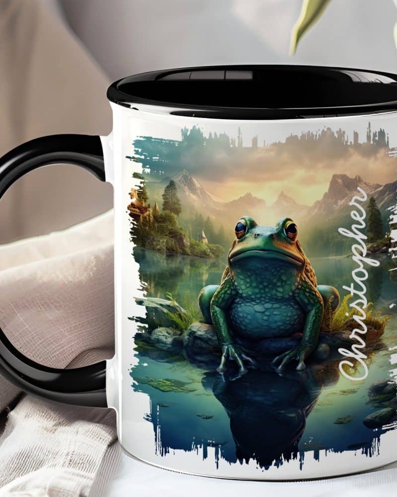 Black-handled mug featuring a large frog sitting by a lake at sunset, with the name Christopher on the side.