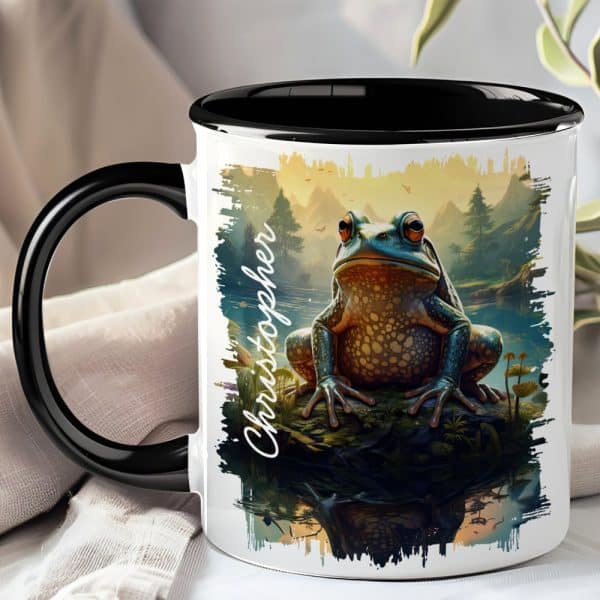 Black-Handled Mug With A Colorful Illustration Of A Large Frog Sitting On A Rock By A Lake, The Name Christopher Is Written On The Side.