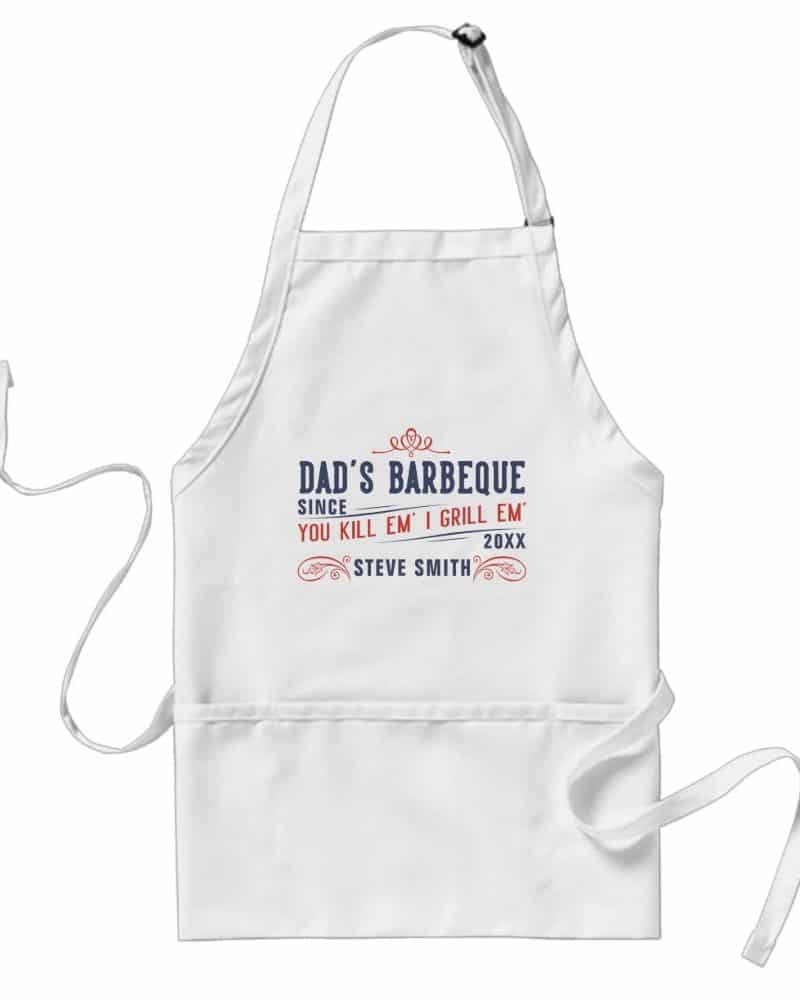 White apron with a personalized barbecue design featuring a name and year.