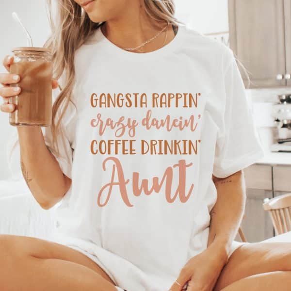 Woman Wearing A White T-Shirt That Says Gangsta Rappin, Crazy Dancin, Coffee Drinkin Aunt.