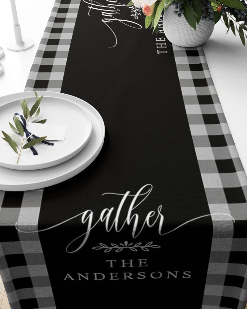 Black and gray buffalo plaid table runner with the word gather and the Andersons family name.