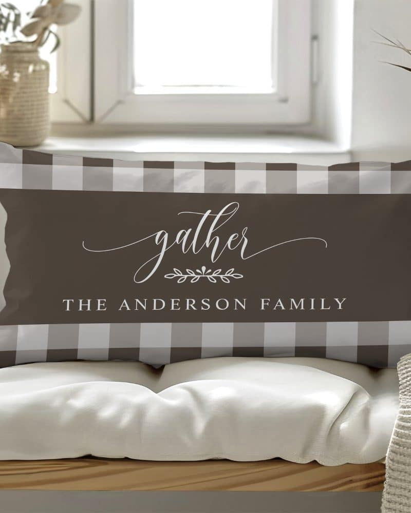 Brown and white gingham pillow with the word gather and The Anderson Family.
