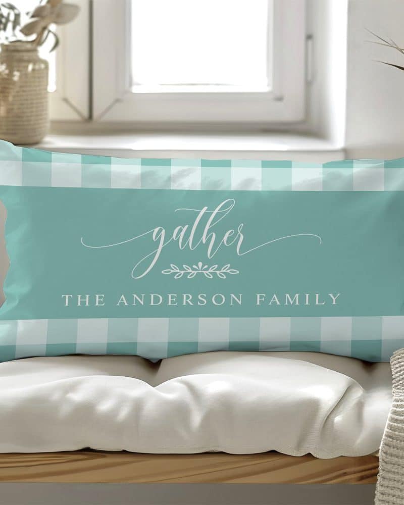 Teal and white gingham pillow with the word gather and The Anderson Family.