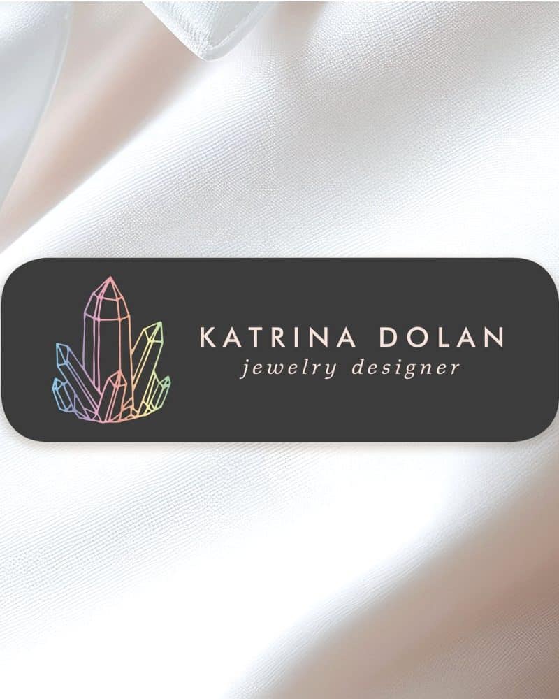 Katrina Dolan jewelry designer logo featuring pastel colored crystals.